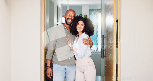 Image of African couple, happy and hug at front door in portrait with pride, care and bonding at new home. Man, woman and smile together with embrace, love and investment with property, real estate or house