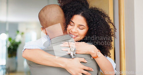 Image of Couple, keys and hug at front door, new home and excited for fresh start with love, care and pride. Man, woman and happy together with embrace, love and investment with property, real estate or house