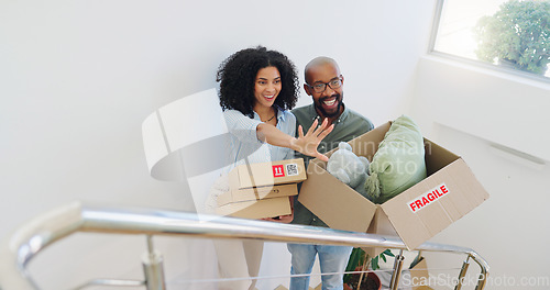 Image of Real estate, box and vision with a black couple moving house for growth, investment or mortgage. Property, smile or happy with a man and woman on stairs in their new home together for future planning