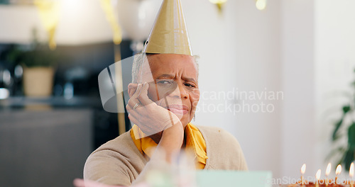 Image of Sad, birthday and portrait of senior woman with depression, grief and lonely in her home. Cake, face and elderly African person alone at a party with disappointment, frustrated or annoyed in a house