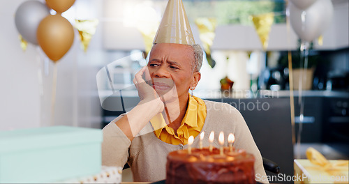 Image of Sad, birthday and senior woman thinking with depression, grief and lonely in her home. Cake, face and elderly African person alone at a party with disappointment, frustrated or annoyed in a house