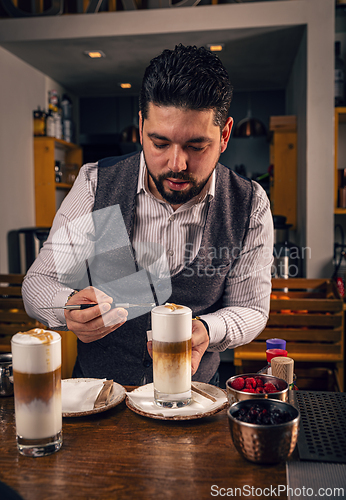 Image of Barista decorating latte macchiato