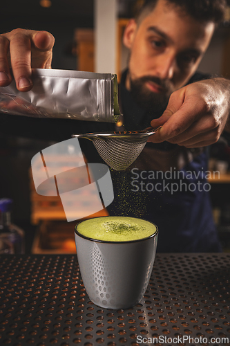 Image of Barman decorated matcha latte