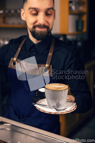 Image of Waiter serving hot coffee
