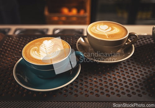 Image of Coffee cup with artistic cream decoration