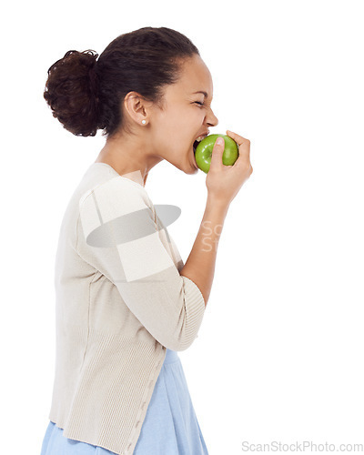 Image of Woman, eating apple and healthy food choice for detox, dental health and wellness on a white background. Profile of a young person biting a green fruit for nutrition, strong teeth or vegan in studio