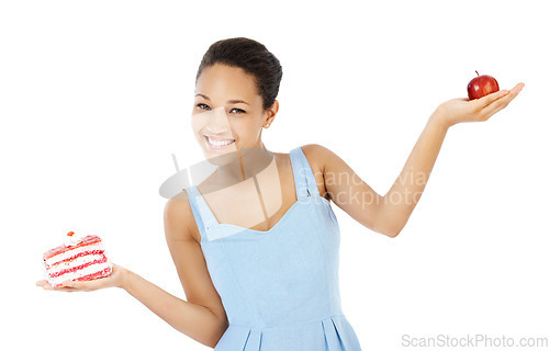 Image of Happy woman, apple and cake for healthy food choice, balance and diet decision in studio. Portrait of young person or model and red fruit versus cream dessert in palm for health on a white background