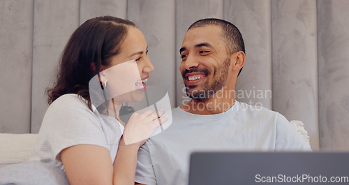 Image of Laptop, conversation and young couple in bed watching movie, film or show together at home. Smile, technology and man and woman relax and talk in bedroom streaming video on computer at modern house.