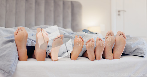 Image of Sleeping feet, relax and family in bed with love, bond or security at home together. Barefoot, children or parents in a bedroom with comfort, trust and care, protection or nap with safety in a house