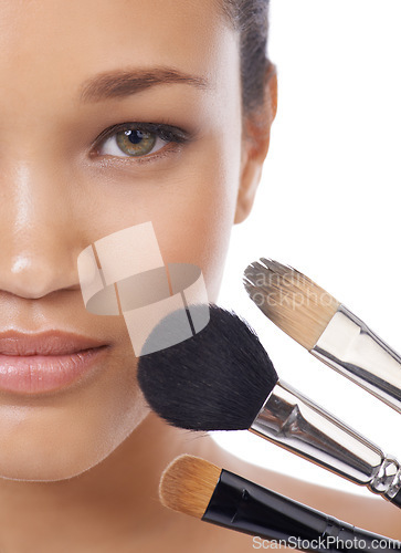 Image of Makeup, brushes and portrait of young woman in studio for beauty, foundation and cosmetics. Face of a model, MUA artist and person with skincare, application tools and product on a white background