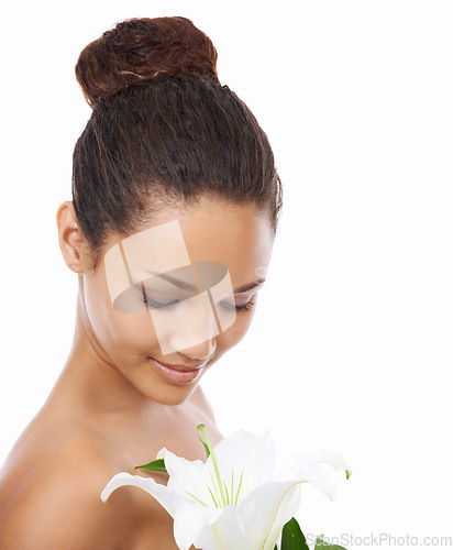 Image of Woman, flower and organic skincare in studio, smiling and happy with facial treatment by white background. Female person, joy and wellness or cosmetics and dermatology, beauty and sustainable product