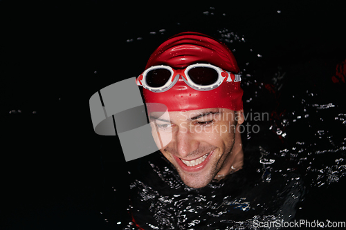 Image of Authentic triathlete swimmer having a break during hard training on night