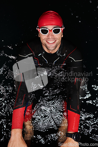 Image of Authentic triathlete swimmer having a break during hard training on night