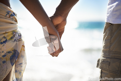 Image of Love, zoom and couple holding hands at a beach with love, respect and trust, bonding and commitment. Support, closeup and people in nature with kindness, security and solidarity on honeymoon vacation