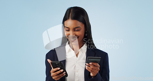 Image of Happy business woman, phone and credit card for payment or online shopping against a blue studio background. Female person or employee smile with mobile smartphone in banking or transaction on mockup