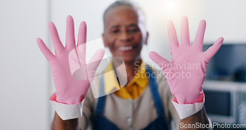 Image of Hands, hygiene and gloves for cleaning with person housekeeper in home kitchen at hospitality guest house. Safety, service and pink rubber or latex with cleaner in apartment for housekeeping chores