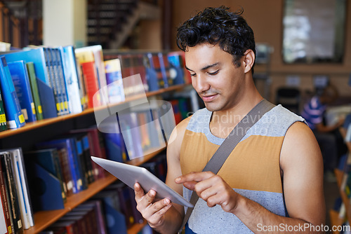 Image of Research, tablet or happy man in library at university, college or school campus for education. Bookshelf, elearning or male student with scholarship studying knowledge, online course or information