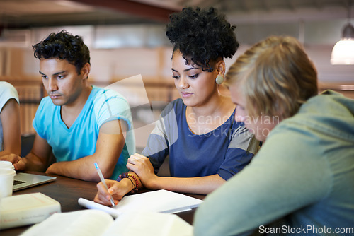 Image of Group, education and students writing in notes studying for exam or learning information in classroom. University, college or diverse learners with teamwork for knowledge, academic course or research
