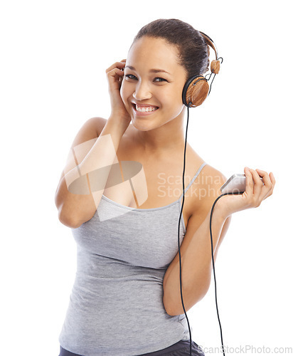 Image of Happy woman, portrait and headphones listening to podcast for audio streaming against a white studio background. Female person smile enjoying sound track, music or playlist on smartphone with headset