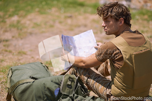 Image of Soldier with map on battlefield, planning battle location or tactical operation goals for mission in war. Man is outdoor at military base camp, check strategy paperwork with army target and attack