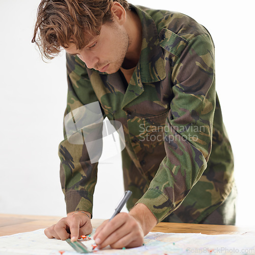 Image of Soldier writing on map, army plan of attack and hero in uniform with operation goals for mission in war. Military man on white background, strategy document with target and battle logistics in studio