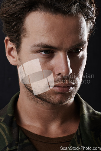 Image of Man is serious in army uniform, soldier or hero in headshot with military service on black background. Face of warrior, security and protection with mission or operation, courage and tough in studio