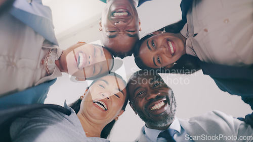 Image of Business people, face and low angle in circle for team building, meeting or motivation together at office. Group of employees or colleagues smile in diversity for teamwork, unity or community below
