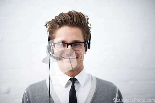 Image of Business man, telemarketing and headphones in portrait, smile and microphone by wall background. Call center employee, worker or person with mic, pride and contact us with voip for technical support