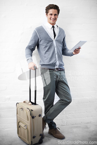 Image of Business man, case or luggage with tablet, portrait and smile with app, flight or travel by wall background. Entrepreneur, person or employee with digital touchscreen, bag and happy for immigration