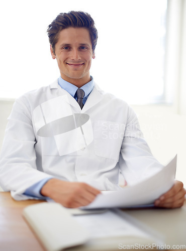 Image of Smile, document and portrait of man doctor in the office for consultation in a medical hospital. Happy, reading and professional young male healthcare worker with paperwork for research in a clinic.