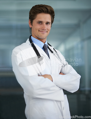 Image of Confident, crossed arms and portrait of man doctor with stethoscope for positive, good and confident attitude. Happy, pride and young male healthcare worker in medical office of hospital or clinic.