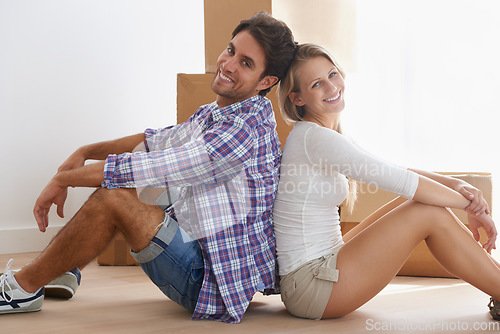 Image of Apartment, portrait and couple moving boxes in new home, property and sitting on floor. Building, man and woman for purchase, real estate and mortgage for relocation, new house and homeowner