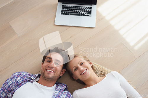 Image of Happy couple, portrait and living room floor with laptop, marriage and relax for love, home and tech. Wife, husband and smile for commitment, bonding together and care for relationship, man or woman