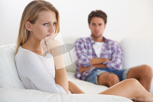 Image of Couple, angry and living room couch with disagreement, upset and thinking with anger, fight or mad. Divorce, betrayal and relationship with cheating, stress and argument for marriage, home or toxic