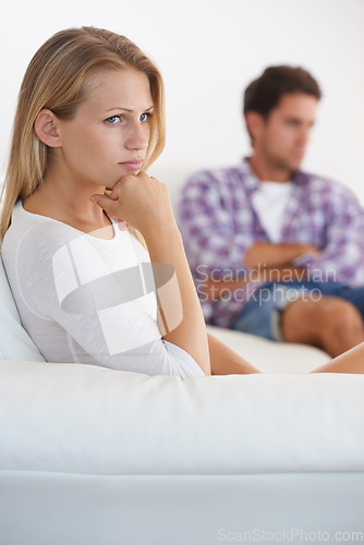 Image of Couple, angry and living room couch with anger, upset and thinking with disagreement fight or mad. Divorce, betrayal and relationship with cheating, stress and argument for marriage, man and woman