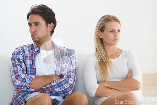 Image of Couple, angry and living room couch with disagreement, upset and thinking with anger, fight or mad. Divorce, betrayal and relationship with cheating, stress and argument for marriage, home or toxic