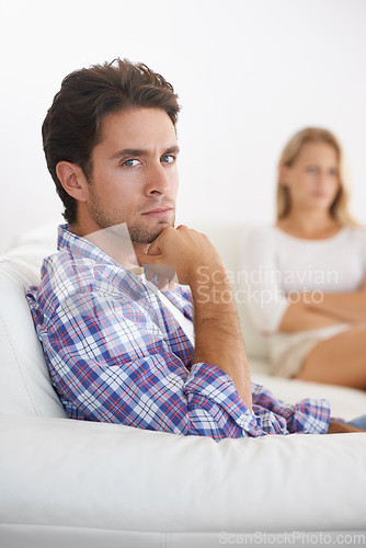 Image of Man, angry and living room couch with disagreement, upset and thinking with anger, fight or mad. Divorce, betrayal and relationship with cheating, stress and argument for marriage, home and woman