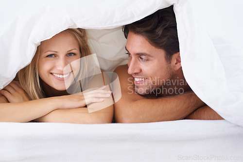 Image of Covers, portrait or happy couple in bed on holiday vacation or romantic honeymoon to celebrate marriage. Morning, love or people with smile in home, house or hotel together with duvet, bond or care