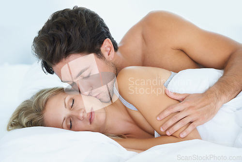 Image of Man, kiss or woman sleeping in bed for fatigue, peace or dreaming to relax on holiday vacation. Couple, romantic love or tired wife on break enjoying nap, bedroom sleep or resting at night in home