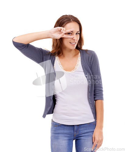 Image of Portrait, fashion and peace sign on eye of woman in studio isolated on white background for style. Smile, trendy and hand gesture with happy young model person in casual or relaxed clothes outfit