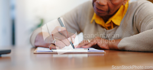 Image of Senior woman, hands and writing agreement on contract, form or application for retirement plan or insurance at home. Closeup of elderly female person signing documents or paperwork on table at house