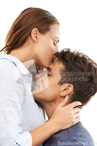 Image of Happy couple, hug and kiss for love, care or compassion in trust or embrace on a white studio background. Handsome man and woman kissing forehead for romance, affection or relationship together