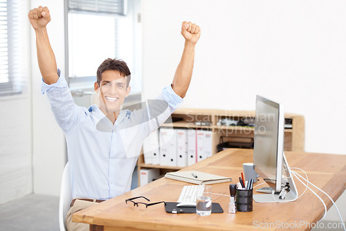 Image of Happy businessman, portrait and fist pump in celebration for winning, success or bonus promotion at office. Excited man or employee smile by desk for prize, deal or good news on computer at workplace