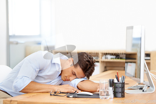 Image of Businessman, sleeping and computer on desk at office in fatigue, burnout or mental health. Tired man or employee asleep or taking a nap in relax or rest sitting on chair or table by PC at workplace