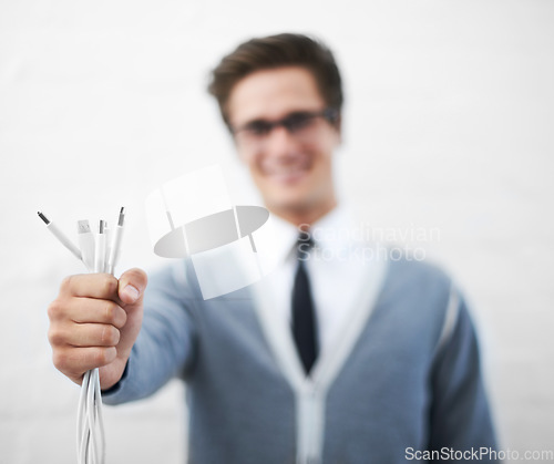 Image of Man, cables and businessman in fashion, smiling and happy for connection, professional and employee..Technician, technical geek and electrician as manager and stylish man in corporate outfit