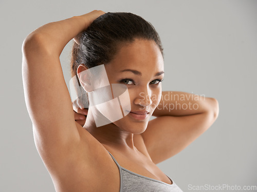 Image of Fitness, tie hair or portrait of happy woman isolated on grey background for wellness or sports. Smile, female athlete or person with hairstyle ready to start exercise, training or workout in studio