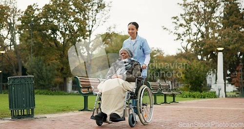 Image of Nurse, walking and park with old woman in a wheelchair for retirement, elderly care and physical therapy. Trust, medical and healthcare with senior patient and caregiver in nature for rehabilitation