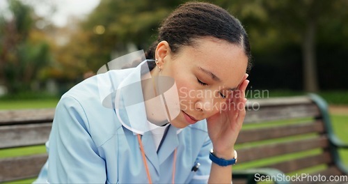 Image of Headache, tired and nurse with woman on park bench for thinking, fatigue and burnout. Mental health, anxiety and stress with female person in nature for frustrated, exhausted and healthcare problem