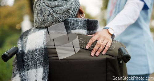 Image of Nurse, hand and park with old woman in a wheelchair for retirement, elderly care and empathy. Trust, medical and healthcare with closeup of patient and caregiver in nature for help and rehabilitation