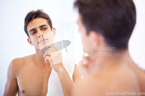 Image of Man, grooming and towel after washing face in mirror, cleaning and skincare or beauty. Male person, bathroom and wellness in morning routine, reflection and hygiene or self care and shaving at home